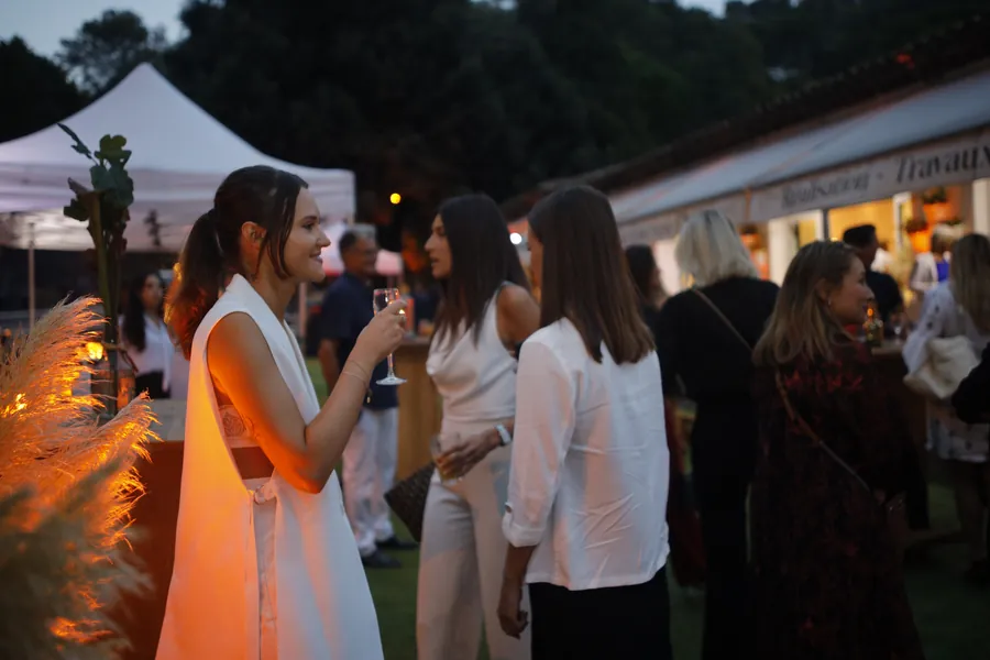 CRD Events reception 2022: guests gathered around the outdoor bar at dusk