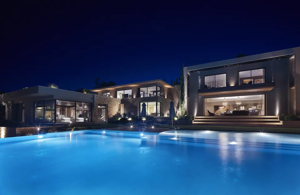 La Réserve — The villa lit up around the pool